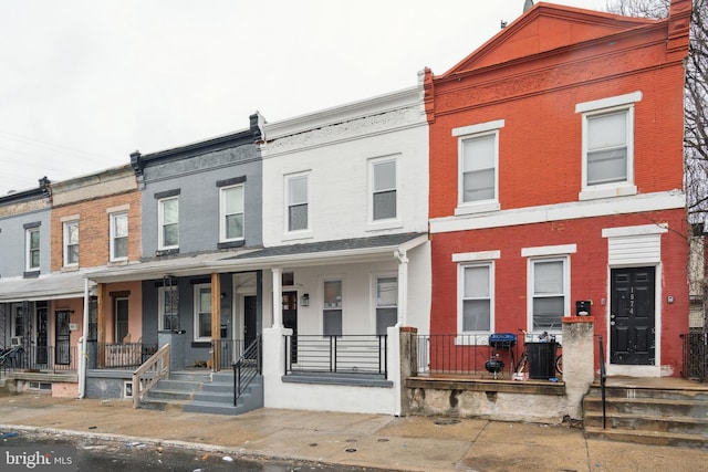 townhome / multi-family property featuring a porch