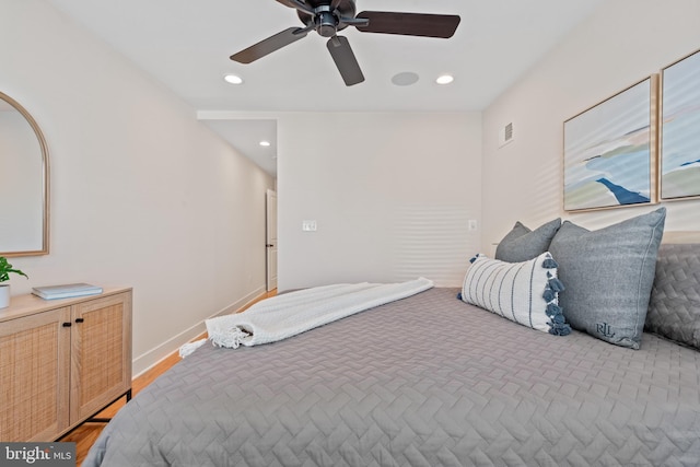 bedroom with hardwood / wood-style floors and ceiling fan