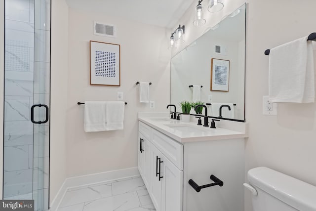 bathroom with a shower with door, vanity, and toilet