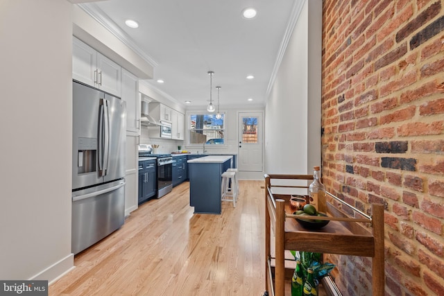 kitchen featuring blue cabinets, hanging light fixtures, a kitchen island, a breakfast bar area, and stainless steel appliances