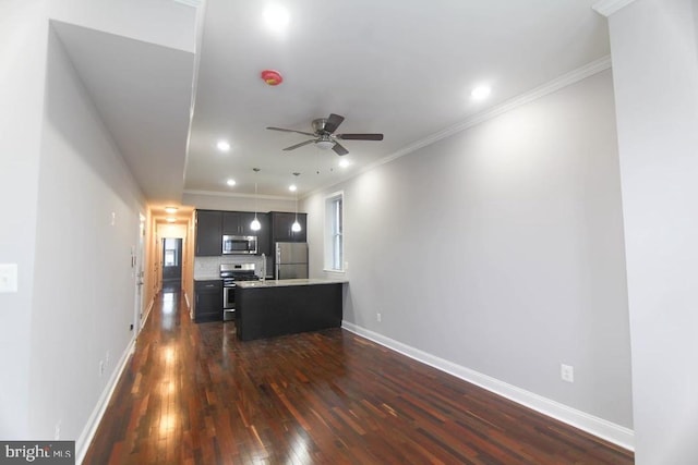 interior space featuring ceiling fan, dark wood-type flooring, backsplash, crown molding, and appliances with stainless steel finishes