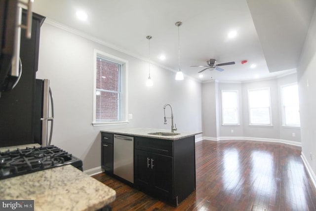 kitchen with ceiling fan, sink, stainless steel appliances, kitchen peninsula, and pendant lighting