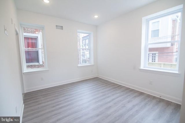 empty room with hardwood / wood-style flooring