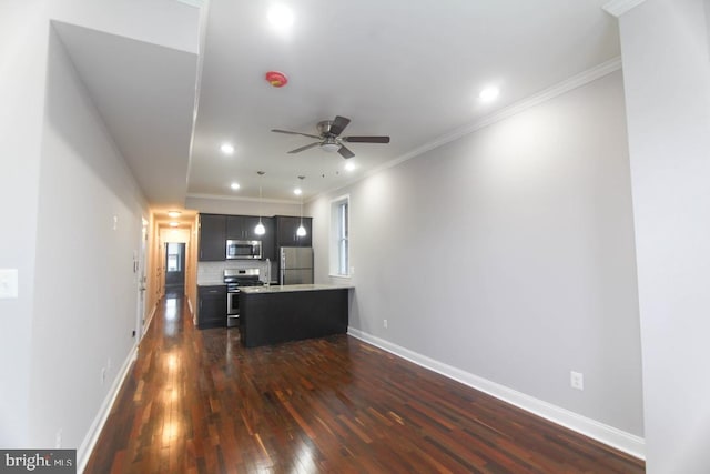 interior space with ceiling fan, stainless steel appliances, dark hardwood / wood-style flooring, decorative backsplash, and a kitchen island