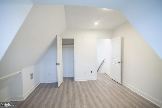 bonus room with light hardwood / wood-style floors and lofted ceiling