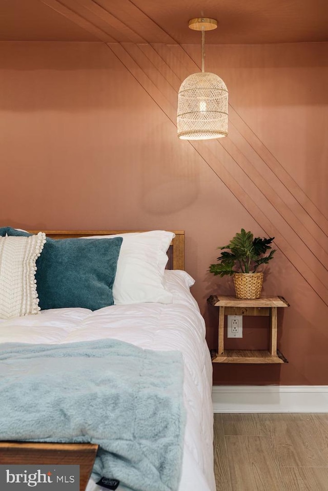 unfurnished bedroom with wood-type flooring, wooden walls, and wooden ceiling