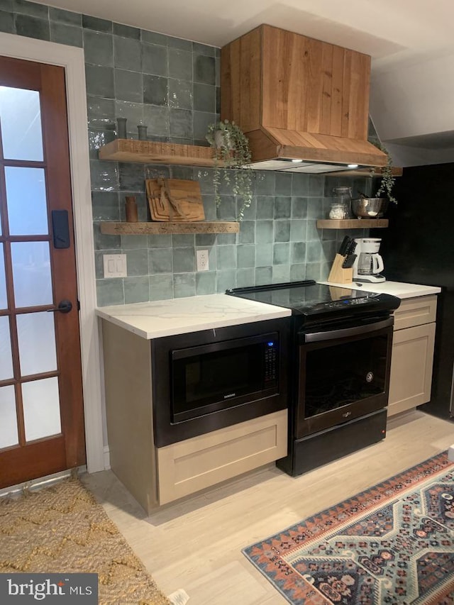 kitchen with decorative backsplash and black appliances