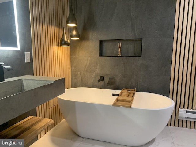 bathroom with a bathtub and tile walls