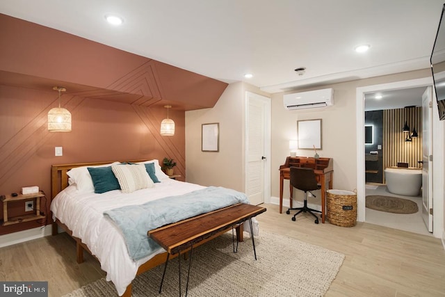 bedroom featuring an AC wall unit and hardwood / wood-style flooring