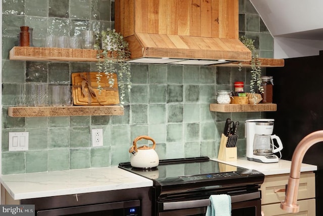 kitchen with range, tasteful backsplash, custom range hood, and lofted ceiling