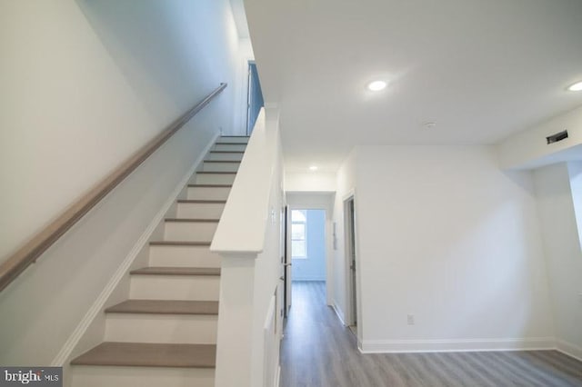 staircase with wood-type flooring