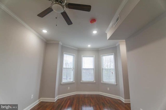 empty room with ceiling fan, crown molding, and dark wood-type flooring