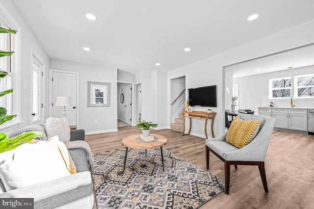 living room featuring plenty of natural light and light hardwood / wood-style flooring