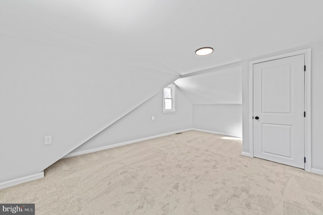 bonus room featuring carpet and vaulted ceiling