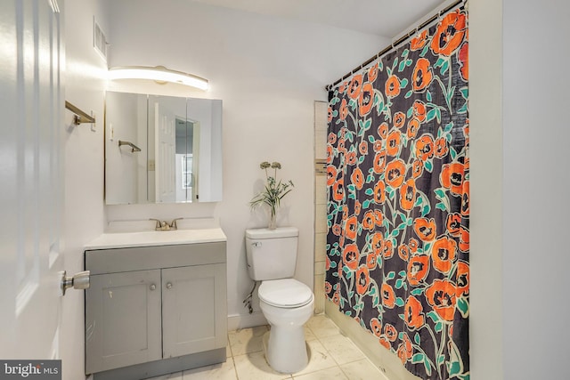 bathroom with tile patterned flooring, vanity, and toilet