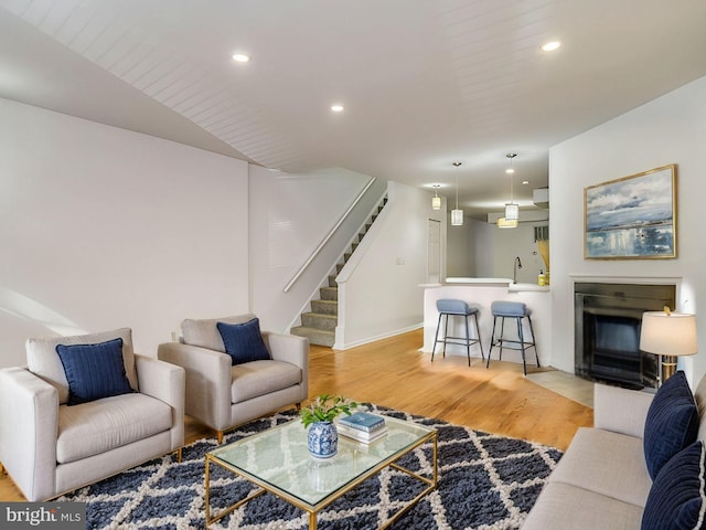 living room featuring light wood-type flooring and sink