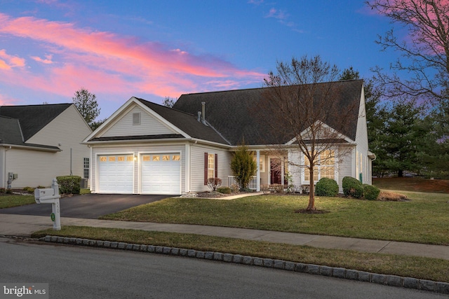 view of front of property with a yard and a garage