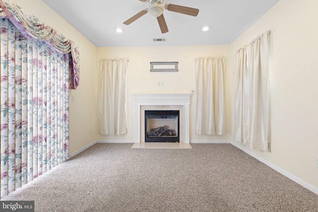 unfurnished living room with carpet flooring, ceiling fan, and plenty of natural light