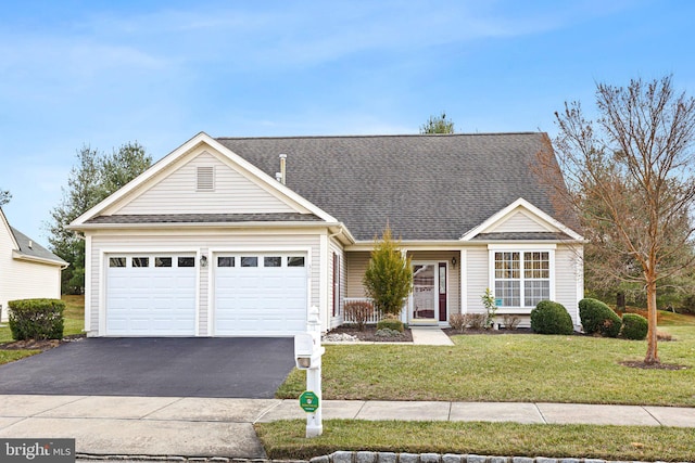 ranch-style house featuring a garage and a front lawn