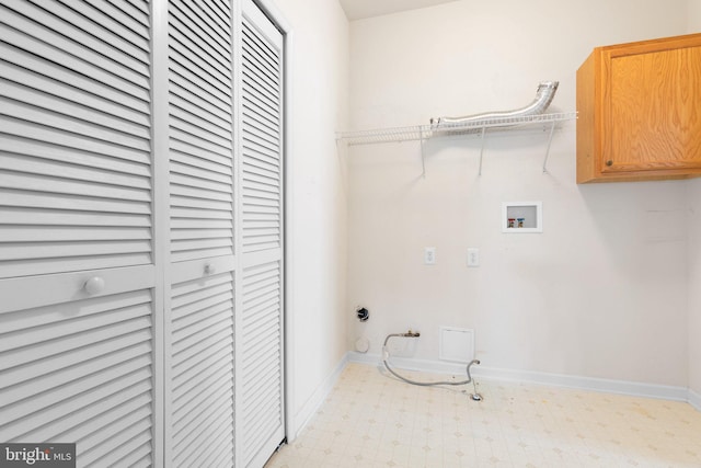 washroom featuring hookup for a gas dryer, hookup for a washing machine, and cabinets