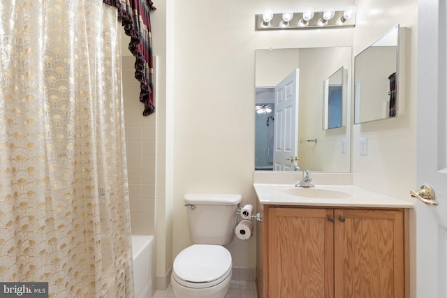 full bathroom featuring ceiling fan, tile patterned flooring, toilet, shower / tub combo with curtain, and vanity