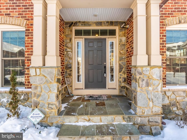 view of snow covered property entrance