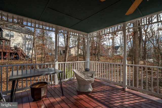 wooden deck featuring ceiling fan