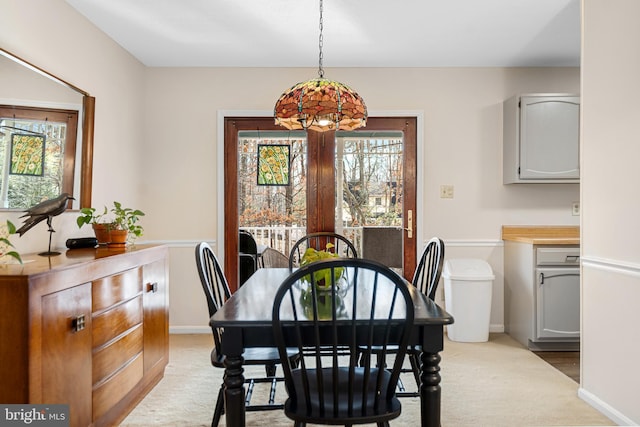 carpeted dining area featuring a wealth of natural light