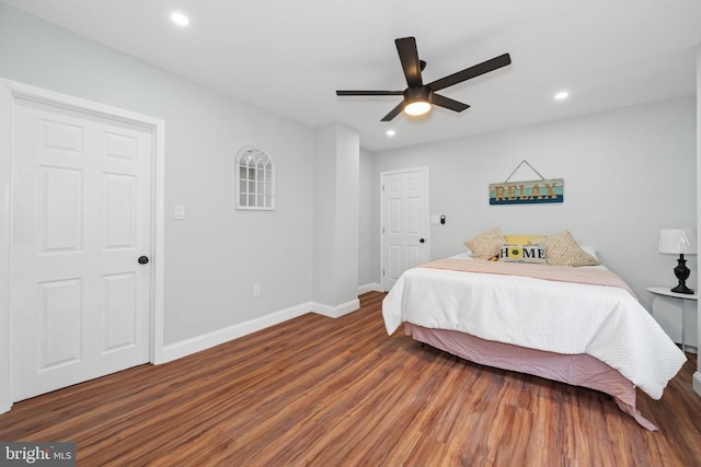 bedroom with ceiling fan and dark wood-type flooring