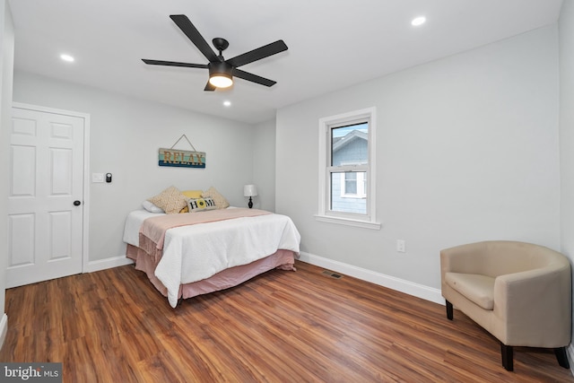 bedroom featuring ceiling fan and dark hardwood / wood-style flooring