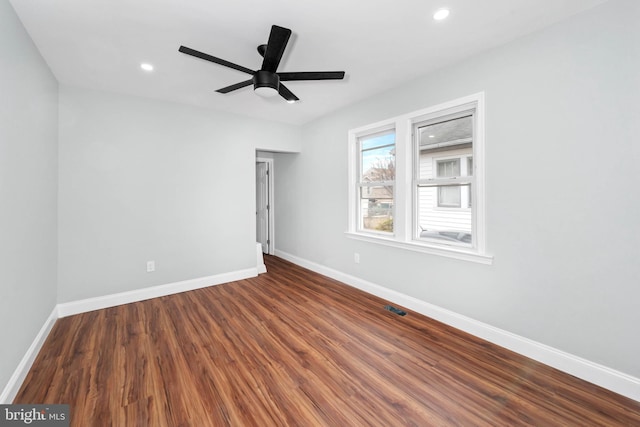 unfurnished room featuring ceiling fan and dark wood-type flooring