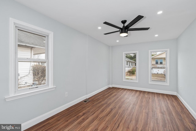 empty room with dark hardwood / wood-style floors and ceiling fan