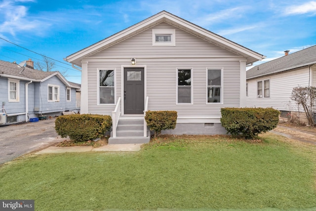 bungalow with a front lawn