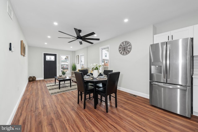 dining area featuring ceiling fan and dark hardwood / wood-style flooring