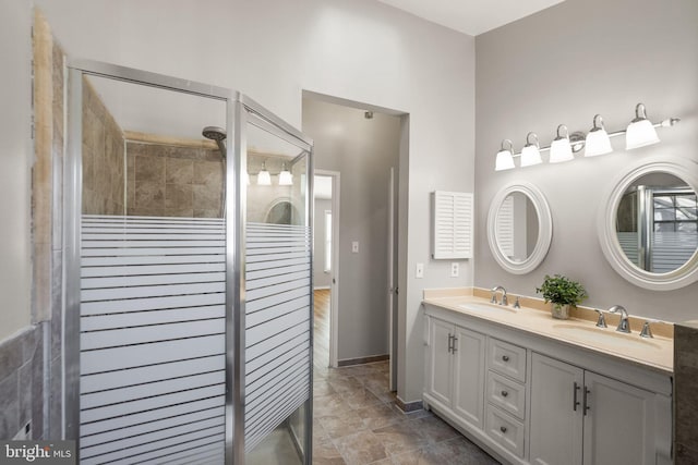 bathroom featuring vanity and a shower with shower door