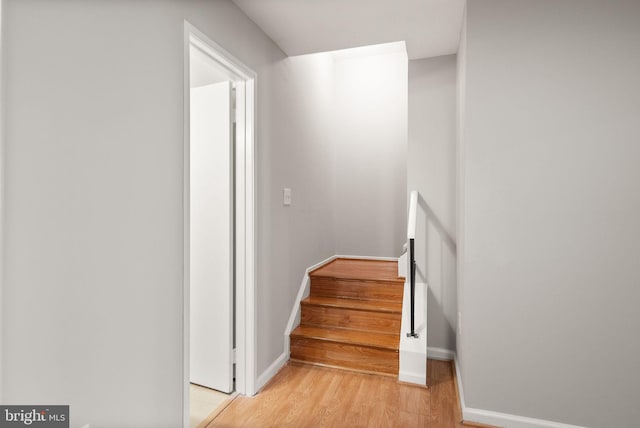 stairs featuring hardwood / wood-style flooring