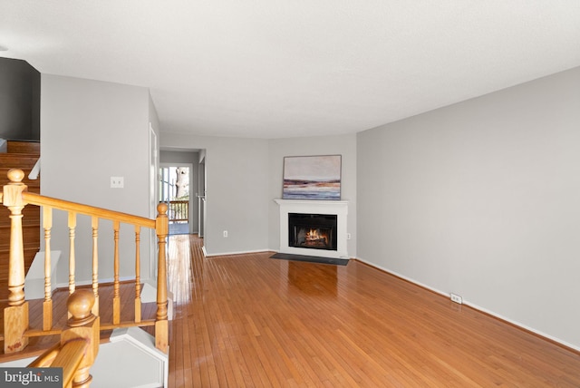 unfurnished living room with wood-type flooring