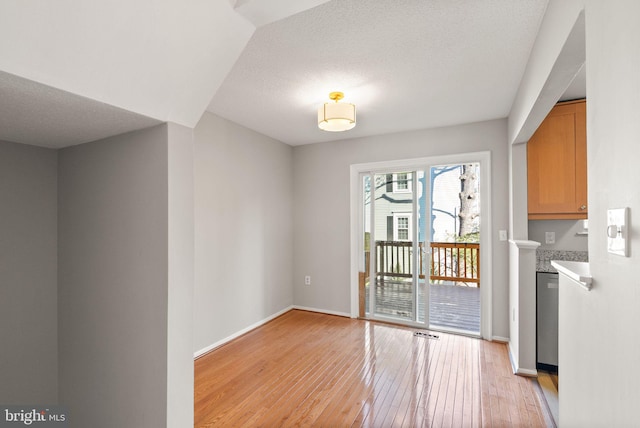 entryway featuring a textured ceiling and light wood-type flooring