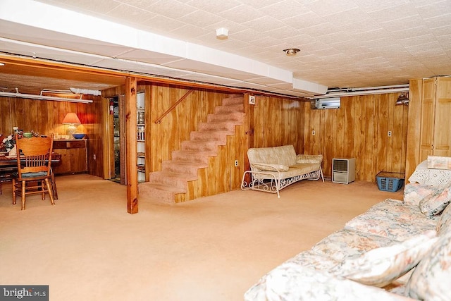 basement with carpet flooring and wooden walls