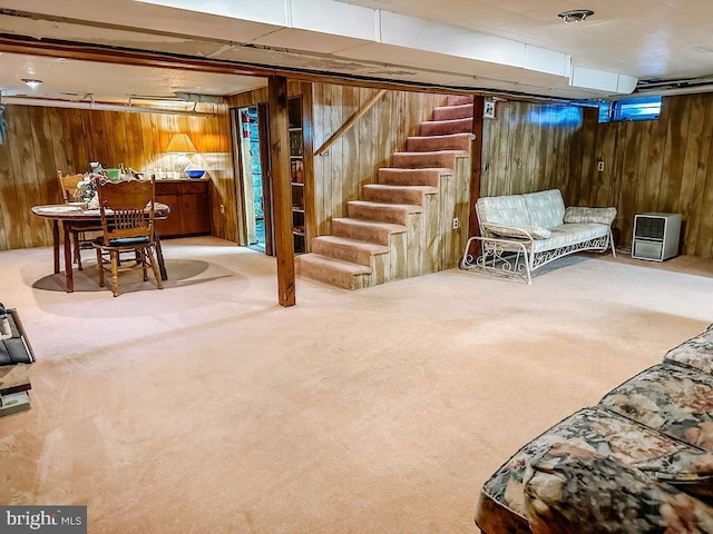 basement with carpet flooring and wood walls