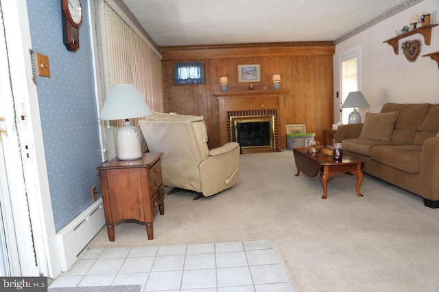 carpeted living room with a brick fireplace, a baseboard radiator, and wood walls