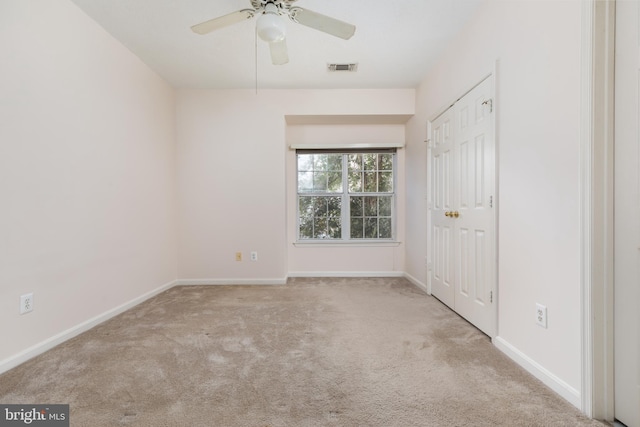 unfurnished bedroom featuring ceiling fan and light carpet