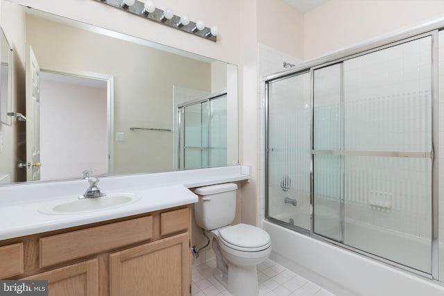 full bathroom with toilet, tile patterned flooring, vanity, and combined bath / shower with glass door