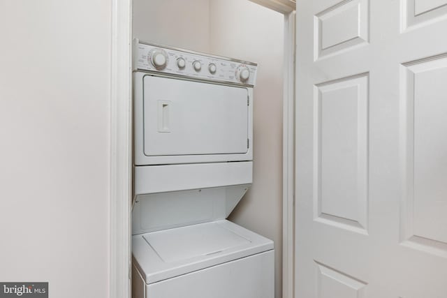 laundry room featuring stacked washer and dryer