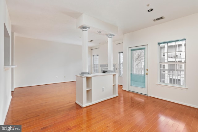 kitchen with hardwood / wood-style floors and decorative columns