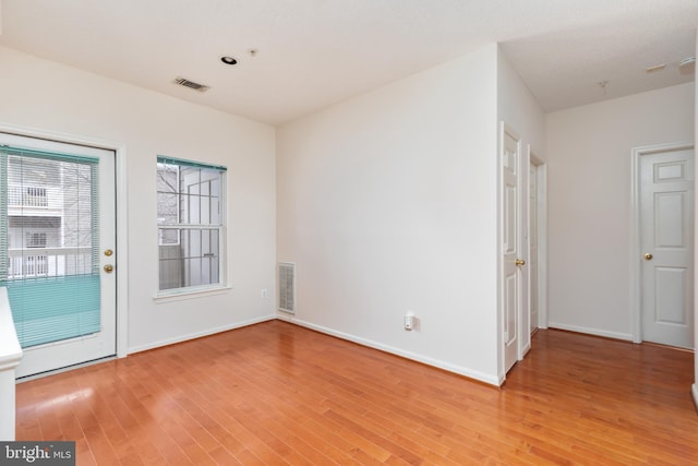 spare room with hardwood / wood-style flooring