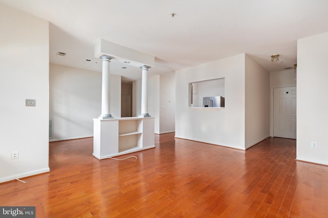 unfurnished room with hardwood / wood-style flooring