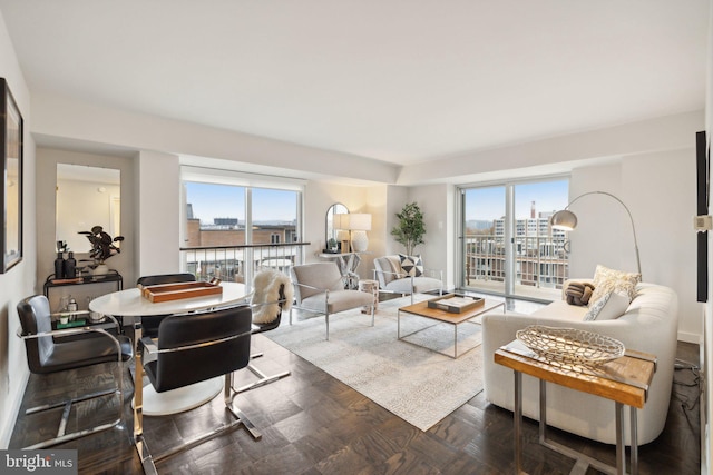 living room with a healthy amount of sunlight and dark parquet flooring