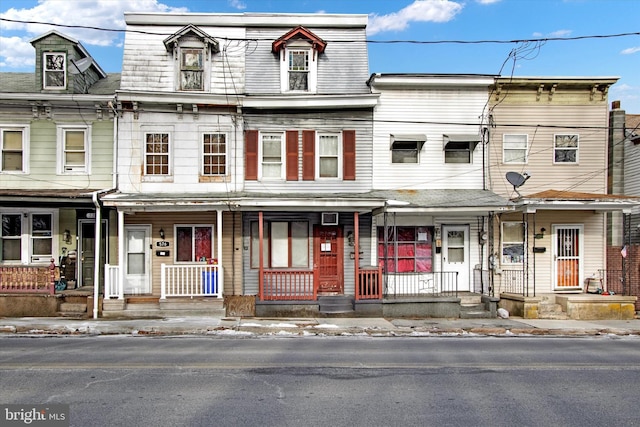 townhome / multi-family property with a porch