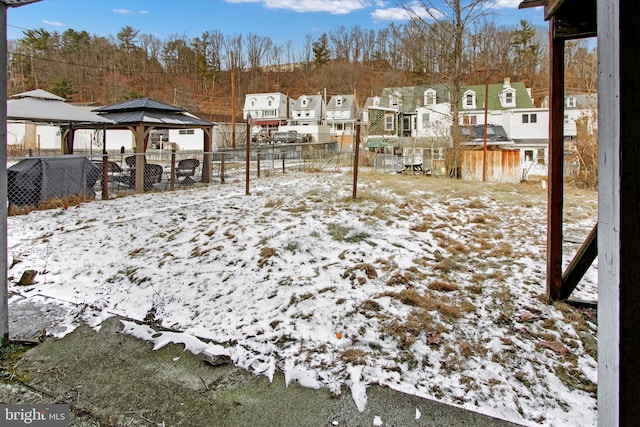 yard covered in snow featuring a gazebo